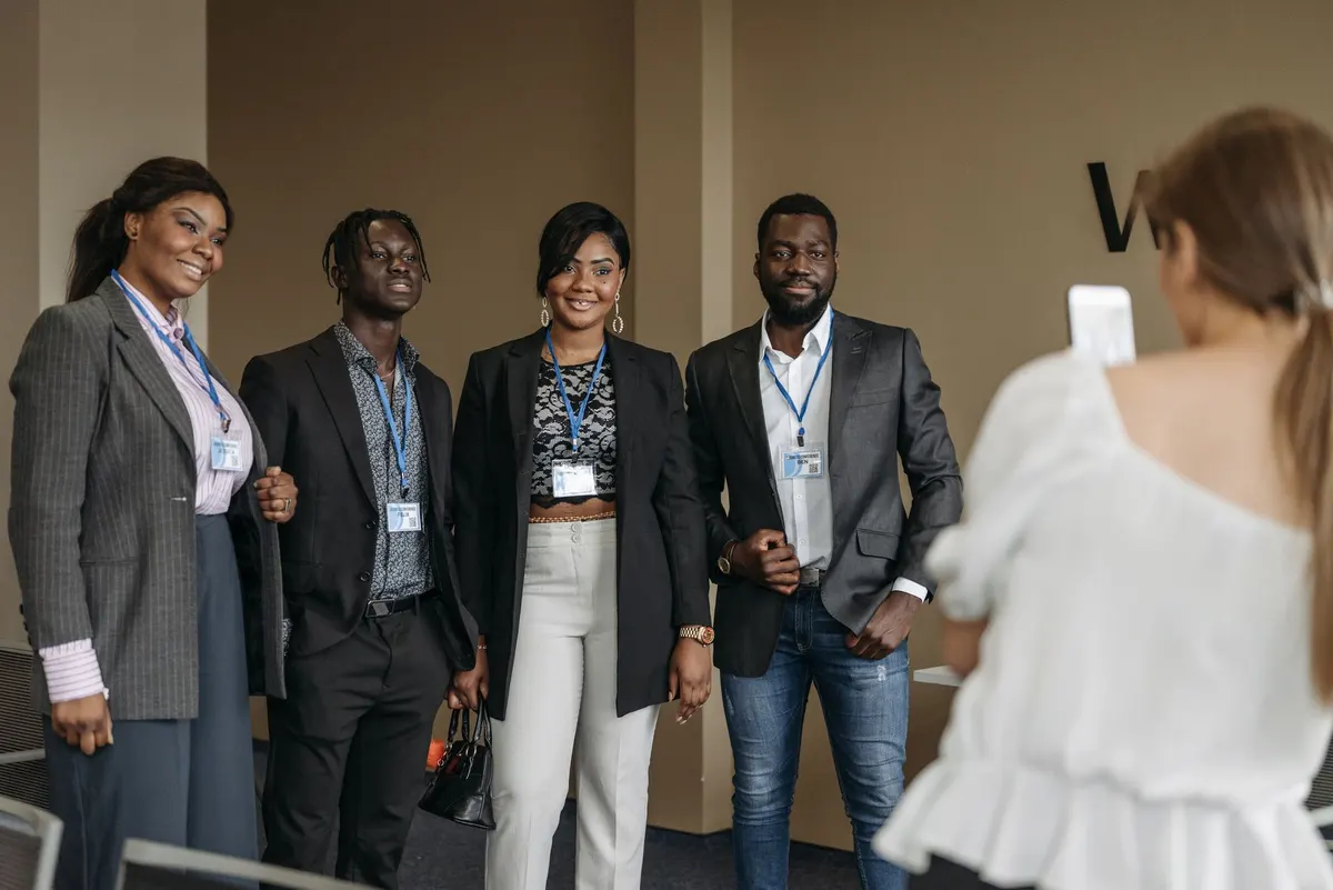 A diverse group of professionals poses together during a business conference for a memorable group photo.